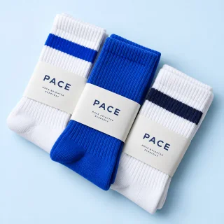 Three pairs of fictional Pace ribbed crew socks in white and cobalt blue